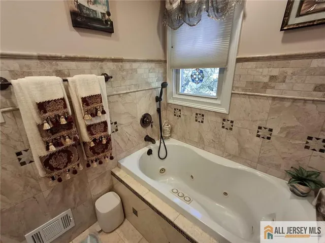a bathroom with a granite countertop sink a toilet and a shower