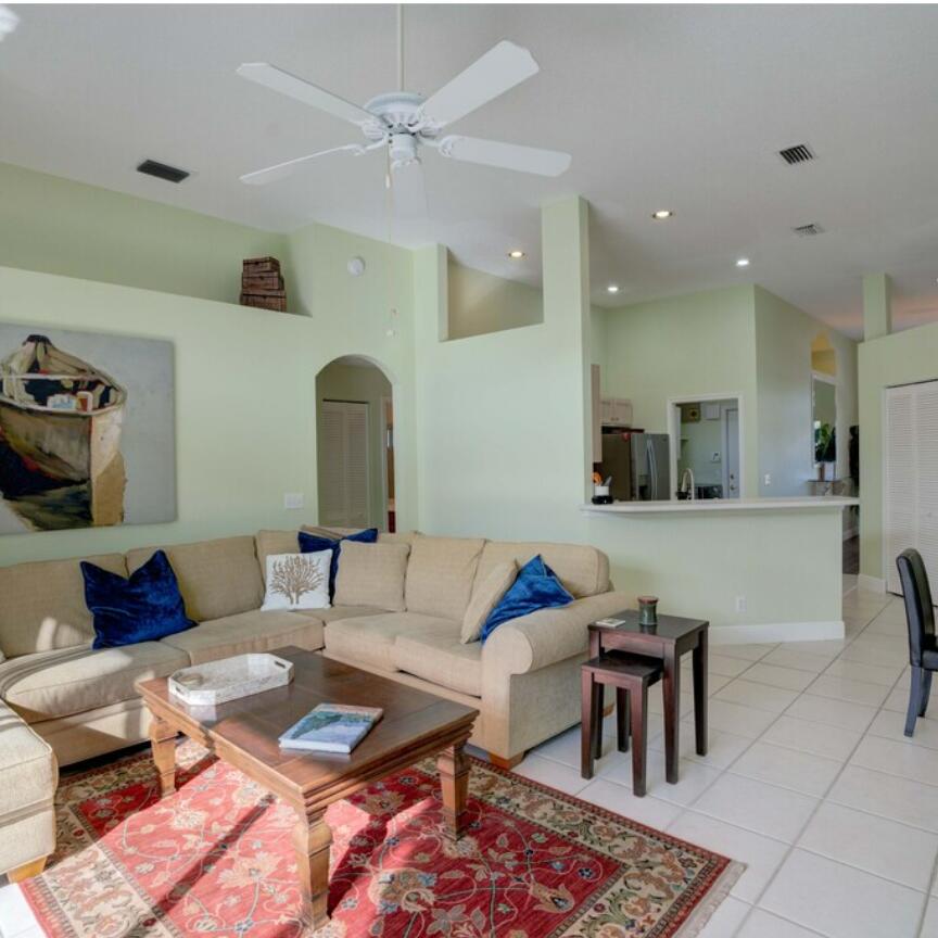 6014 Adams Street Jupiter, FL 33458 - Photo 11 of 15 a living room with furniture and wooden floor
