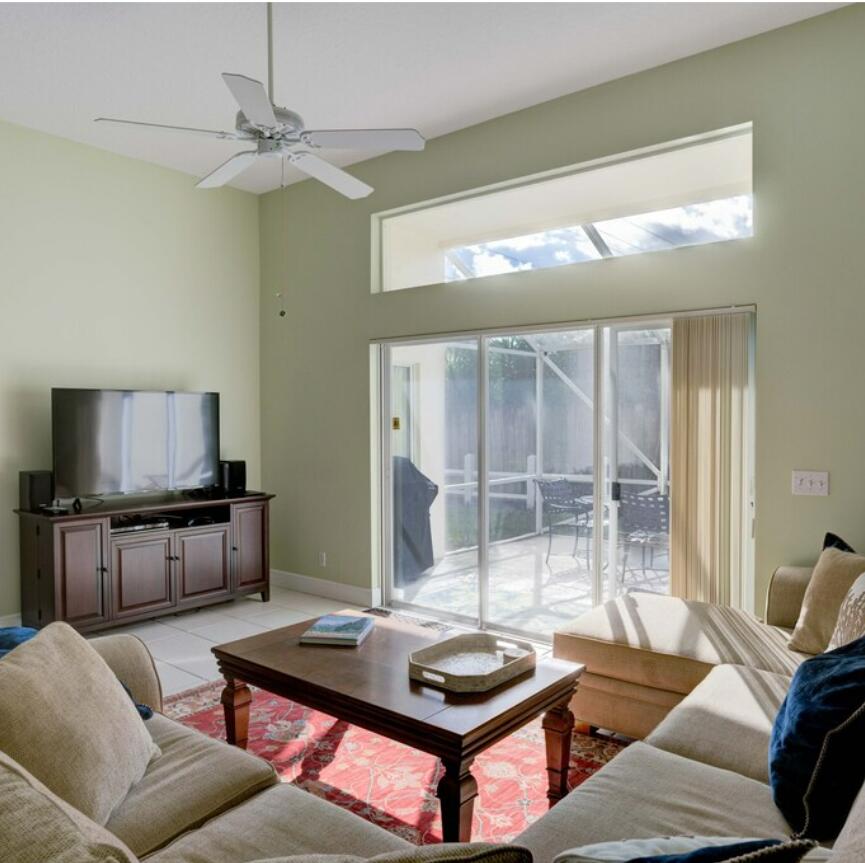 6014 Adams Street Jupiter, FL 33458 - Photo 12 of 15 a living room with furniture and a flat screen tv