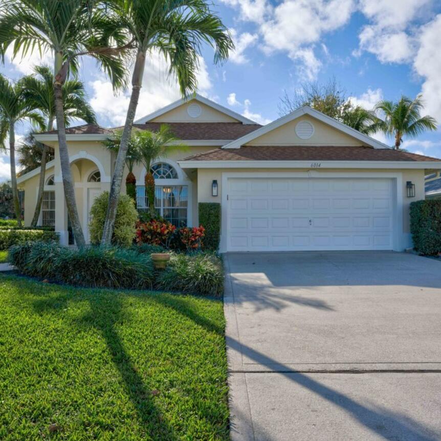 6014 Adams Street Jupiter, FL 33458 - Photo 2 of 15 a front view of house with yard and green space