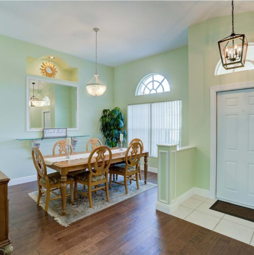 6014 Adams Street Jupiter, FL 33458 - Photo 3 of 15 a view of a dining room with furniture window and wooden floor
