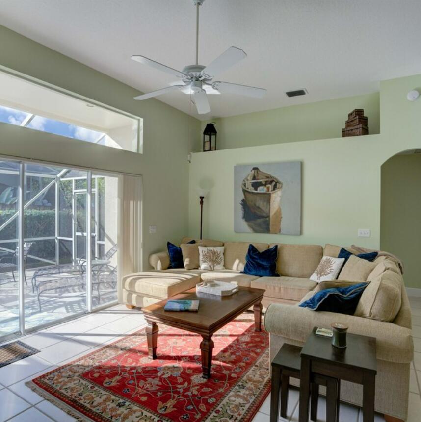 6014 Adams Street Jupiter, FL 33458 - Photo 4 of 15 a living room with furniture and a chandelier