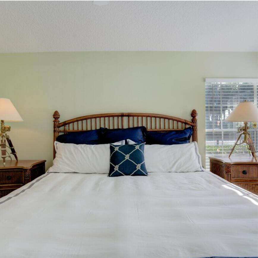 6014 Adams Street Jupiter, FL 33458 - Photo 5 of 15 a bed sitting in a bedroom next to a window