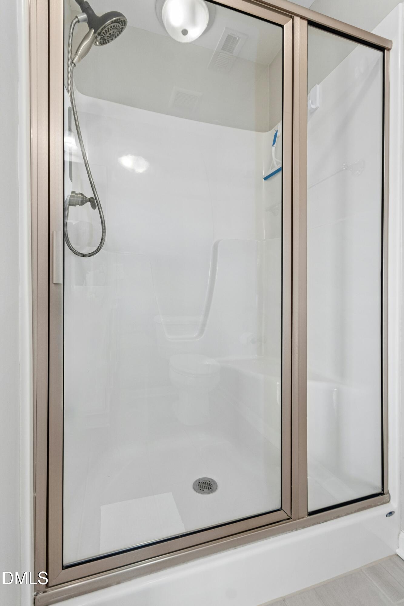 48 Mountain View Drive Garner, NC 27529 - Photo 16 of 29 a bathroom with a glass shower door