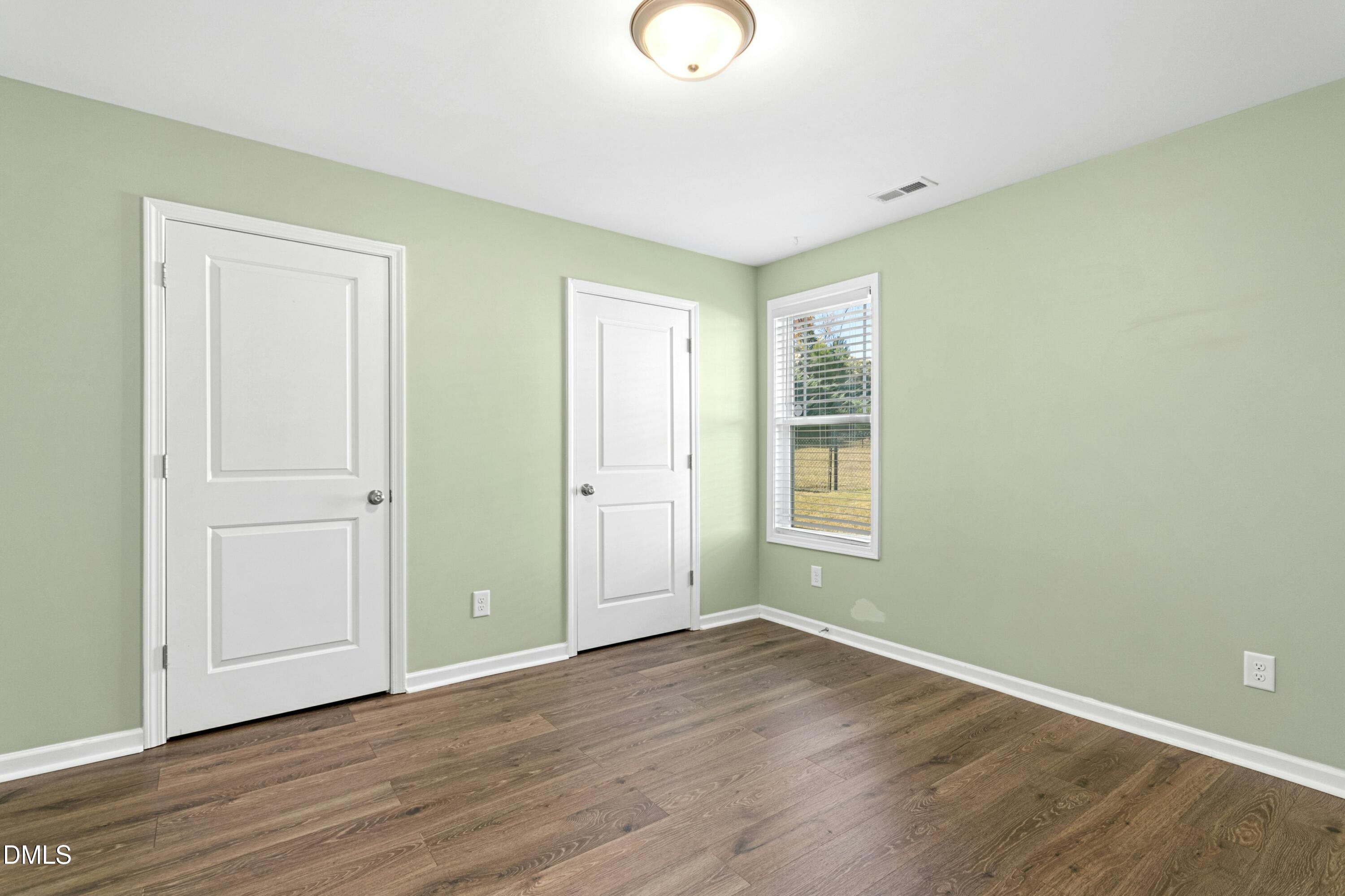48 Mountain View Drive Garner, NC 27529 - Photo 18 of 29 an empty room with wooden floor and window