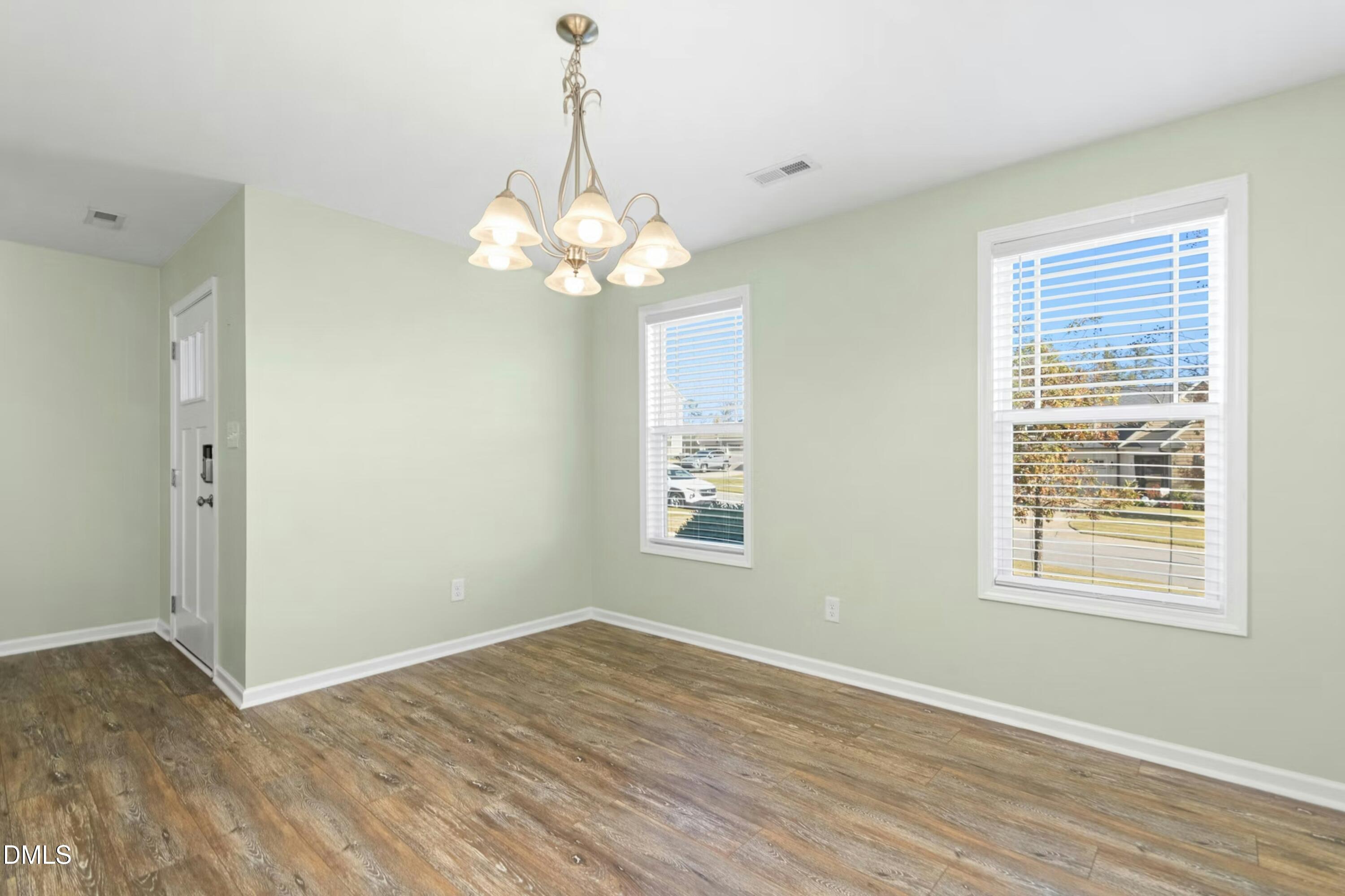 48 Mountain View Drive Garner, NC 27529 - Photo 2 of 29 a view of a big room with wooden floor and windows