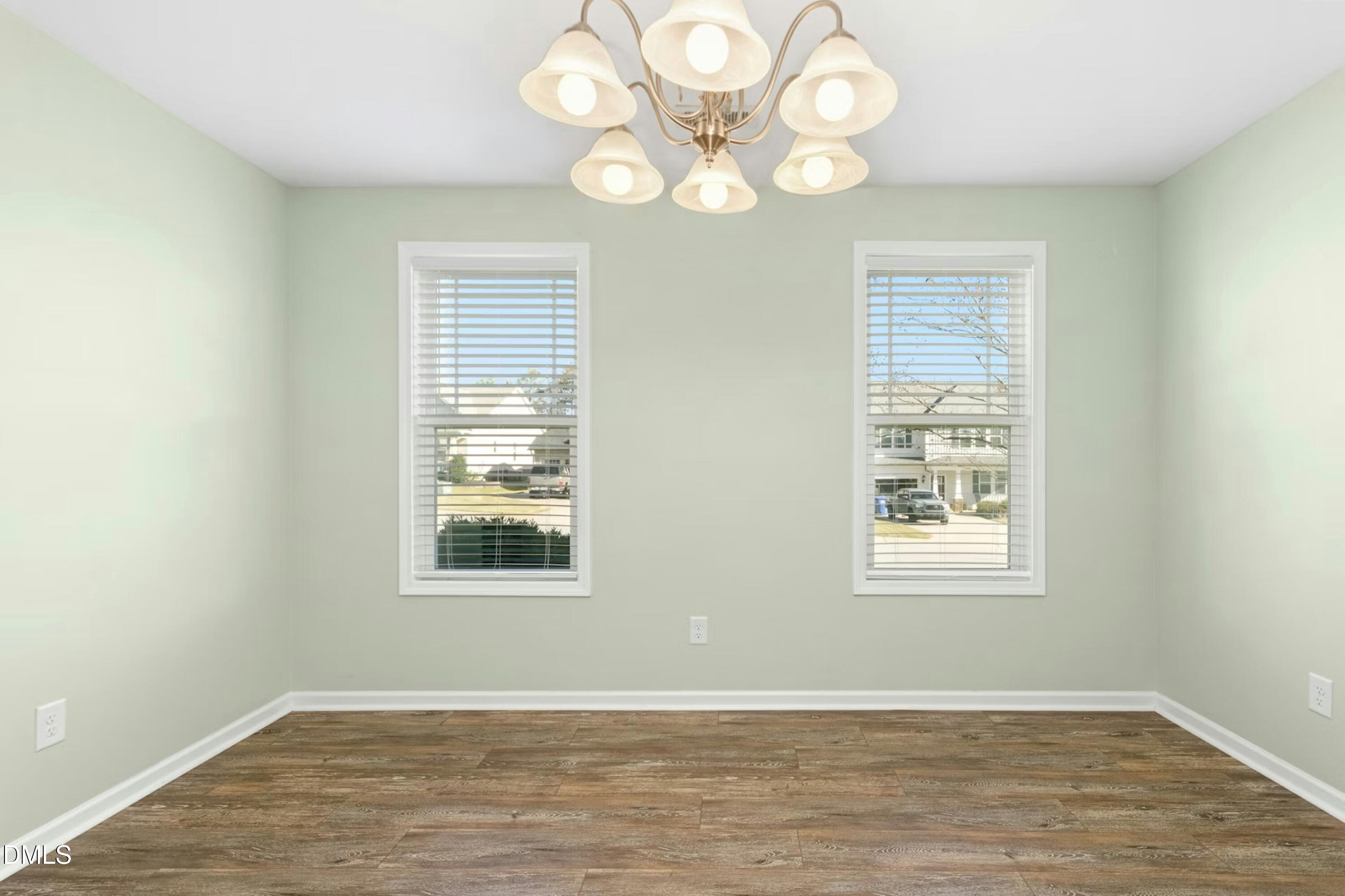 48 Mountain View Drive Garner, NC 27529 - Photo 3 of 29 an empty room with wooden floor and windows
