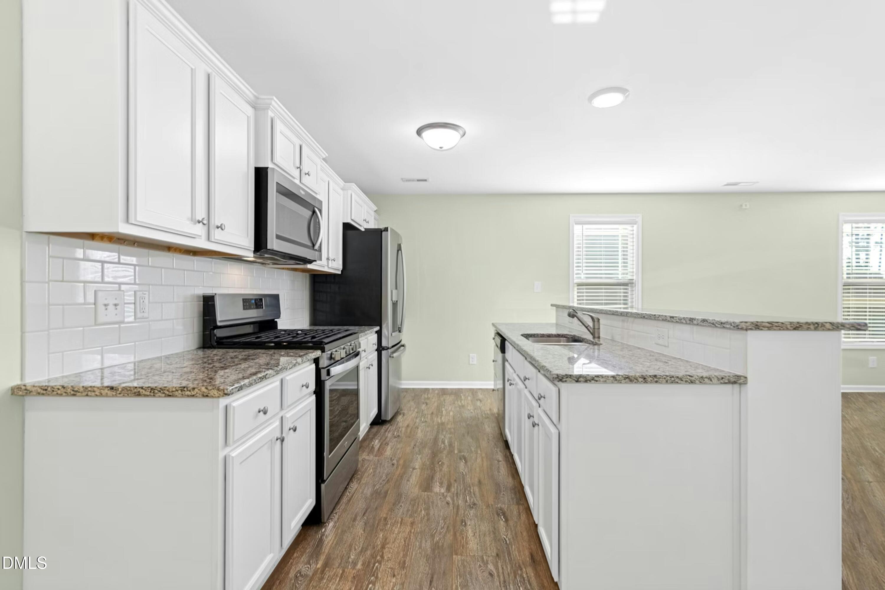 48 Mountain View Drive Garner, NC 27529 - Photo 4 of 29 a kitchen with stainless steel appliances granite countertop a sink stove and cabinets