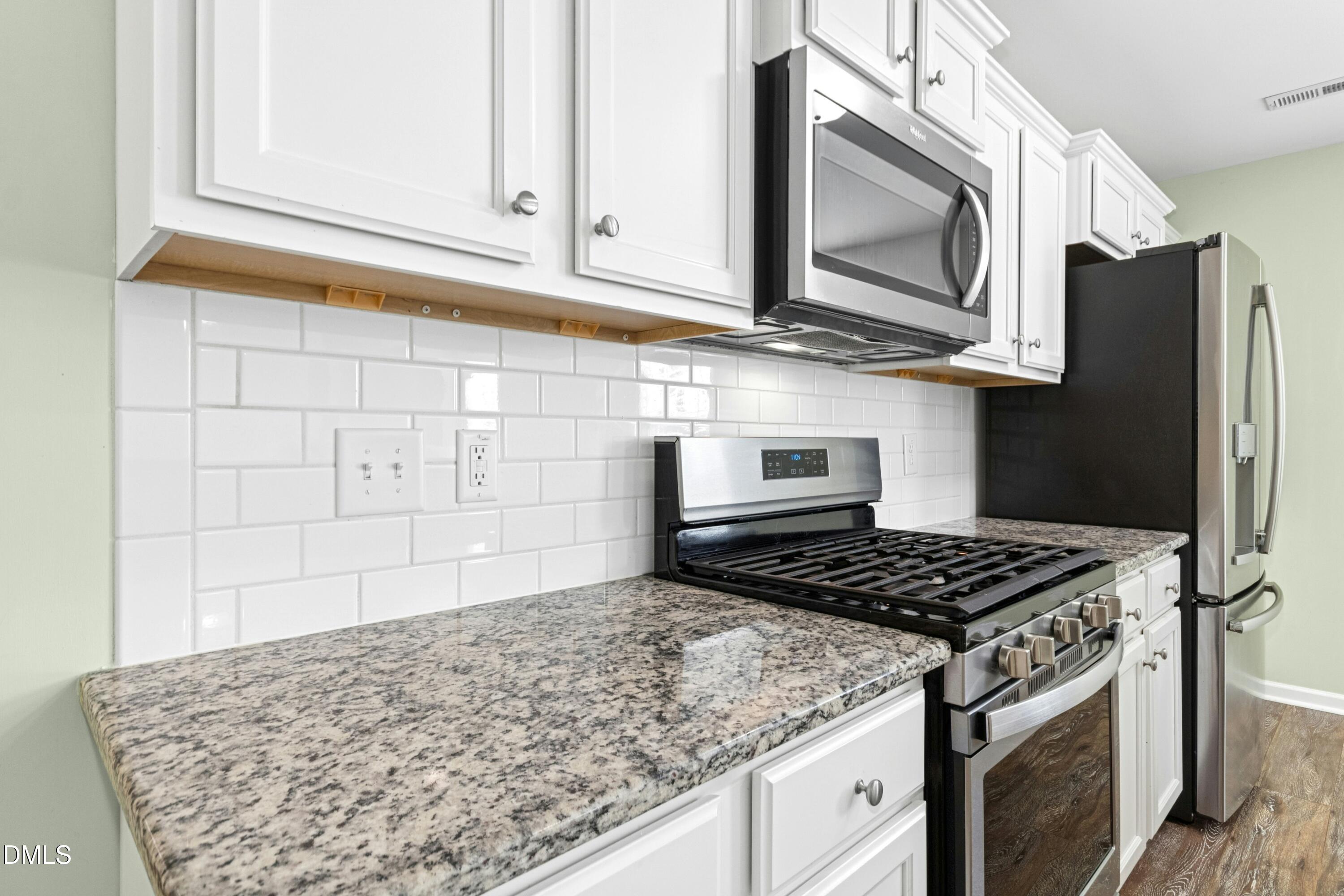 48 Mountain View Drive Garner, NC 27529 - Photo 7 of 29 a kitchen with stainless steel appliances granite countertop a stove and a microwave