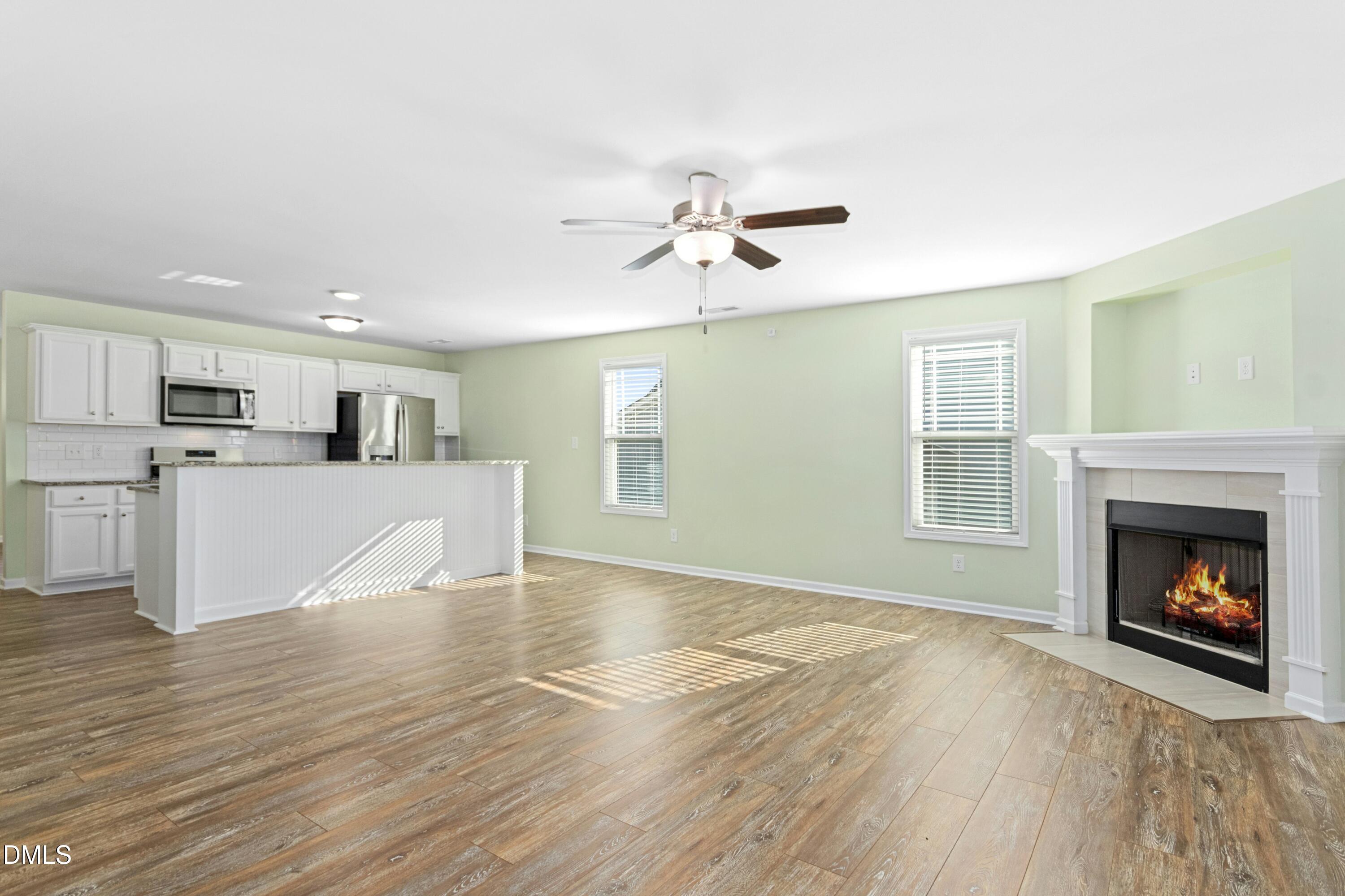 48 Mountain View Drive Garner, NC 27529 - Photo 10 of 29 a view of a kitchen with a sink a fireplace and wooden floor