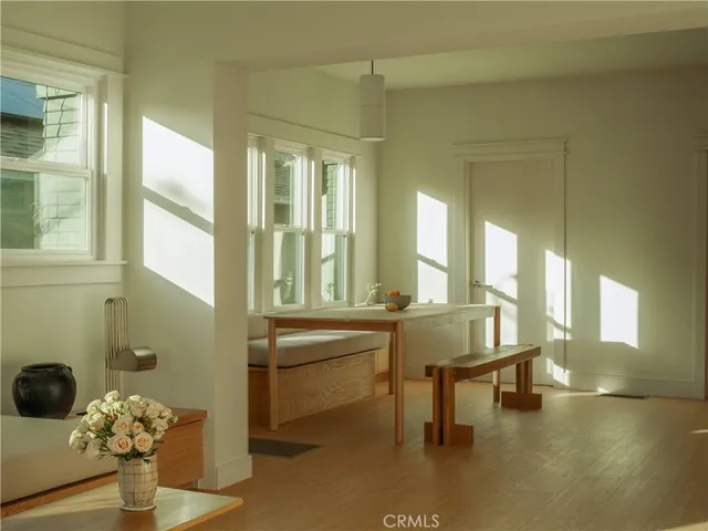 a living room with a window and a chandelier
