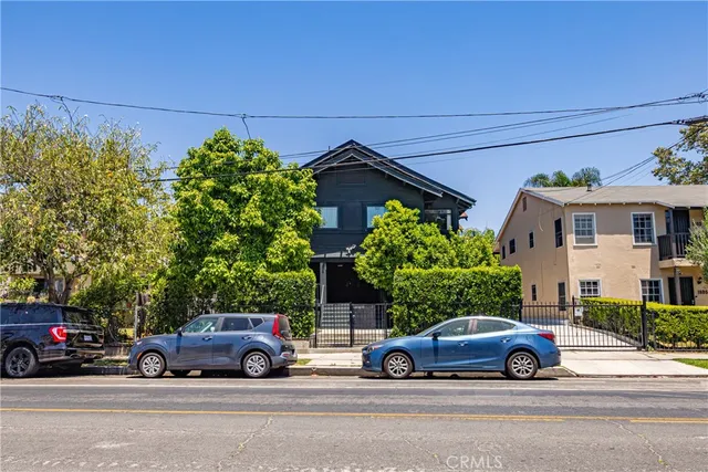 a view of a street with potted plants