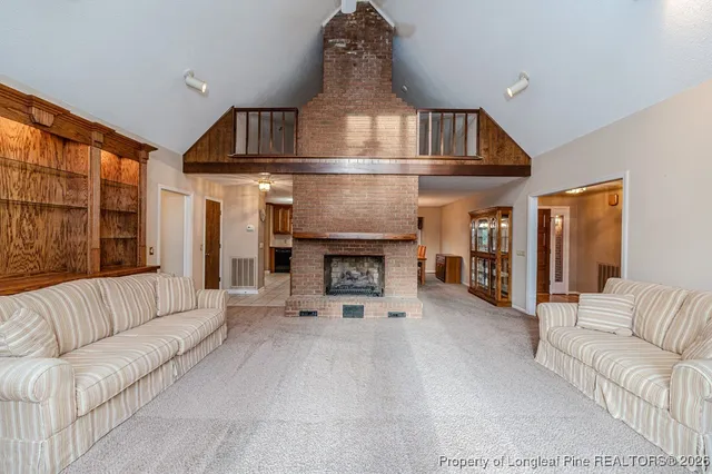 a view of a livingroom with furniture and a fireplace