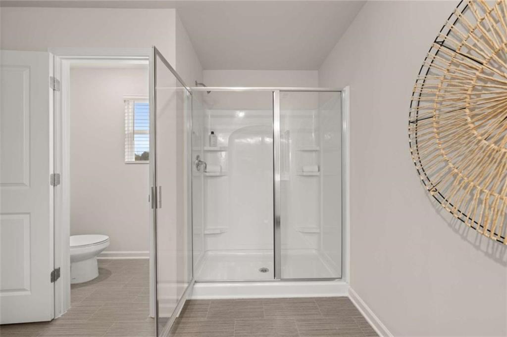 1057 Merritt Drive, Unit 83 Villa Rica, GA 30180 - Photo 19 of 49 a bathroom with a shower and a toilet