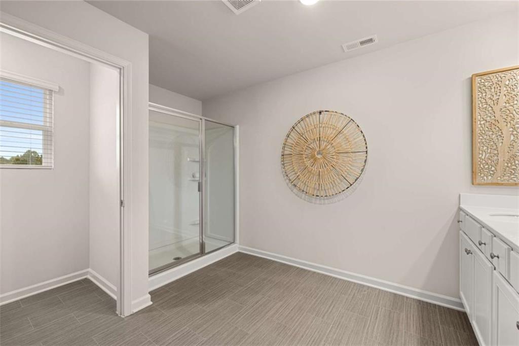 1057 Merritt Drive, Unit 83 Villa Rica, GA 30180 - Photo 22 of 49 an empty room with wooden floor and windows