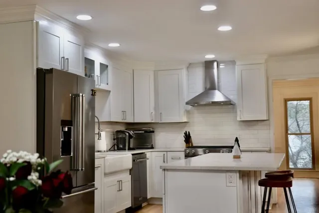 a kitchen with stainless steel appliances granite countertop a refrigerator sink and cabinets