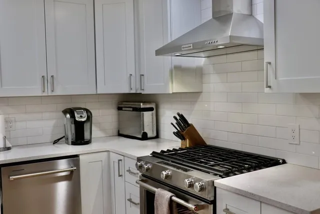 a kitchen with stove and cabinets