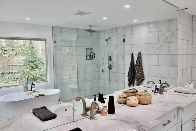 a bathroom with a double vanity sink toilet and shower