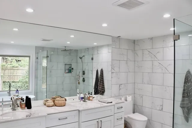 a bathroom with a shower sink and mirror