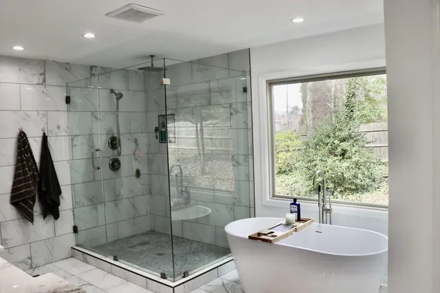 a bathroom with a bathtub and a shower