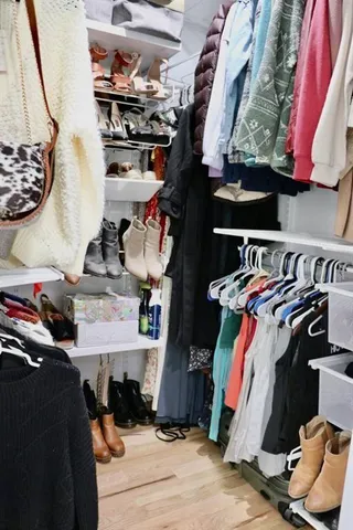 a bathroom with a sink a vanity and a potted plant