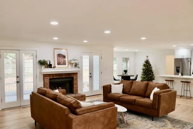 a living room with furniture a fireplace and a flat screen tv