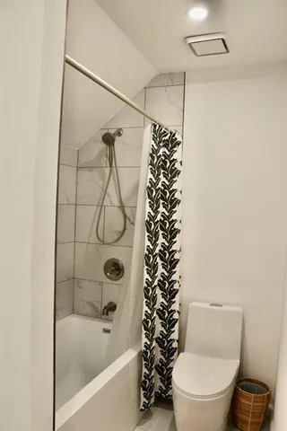 a close view of a faucet a sink and a potted plant