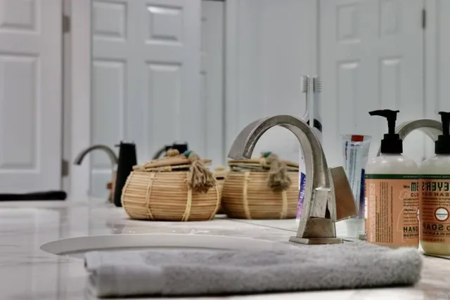 a bathroom with double vanity and a bathtub