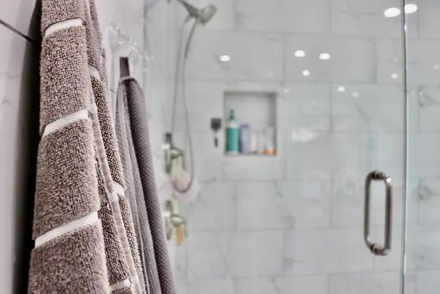 a large bed sitting in a bedroom next to a window