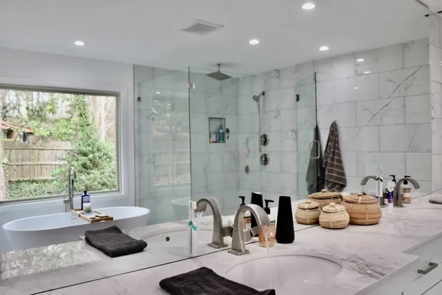 a view of a house with a yard and large tree