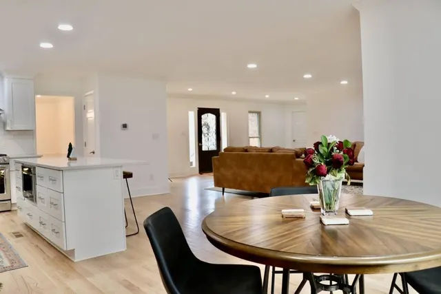 a dining room with furniture and wooden floor