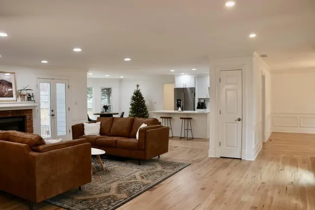 a living room with furniture and a view of kitchen