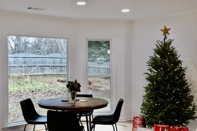 a dining room with furniture and window