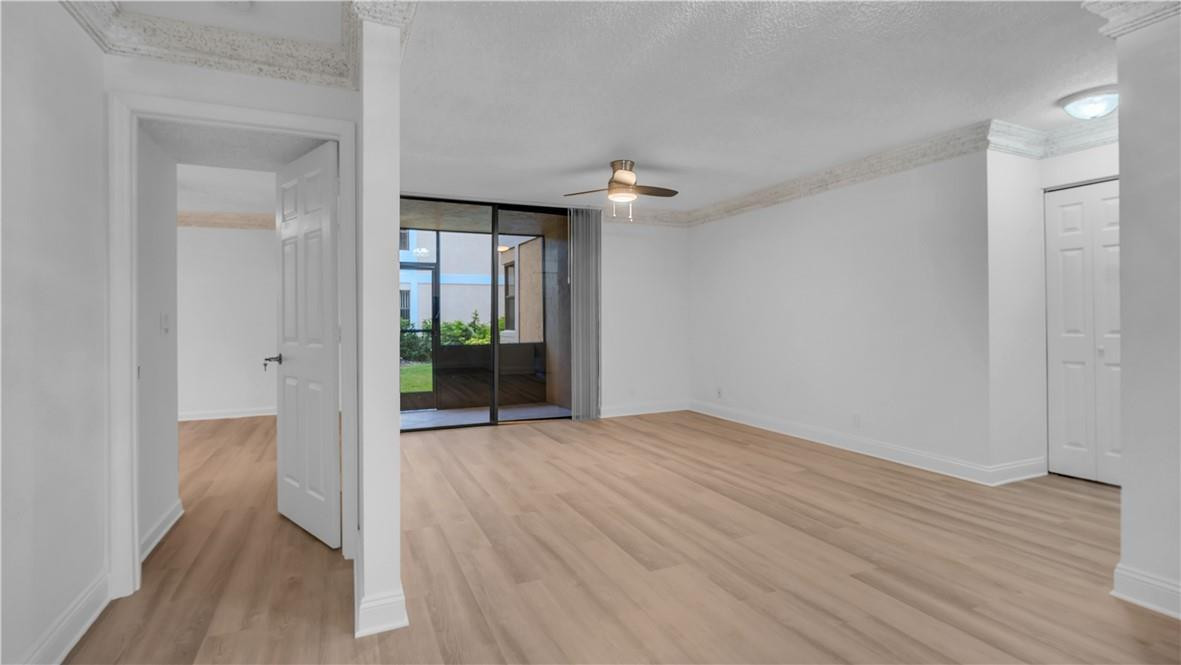 5681 Riverside Drive, Unit 101A6 Coral Springs, FL 33067 - Photo 11 of 25 wooden floor in an empty room with a window