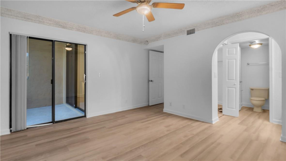5681 Riverside Drive, Unit 101A6 Coral Springs, FL 33067 - Photo 14 of 25 wooden floor in an empty room with a bathroom