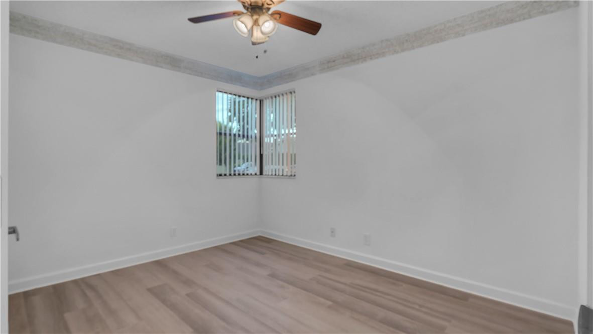 5681 Riverside Drive, Unit 101A6 Coral Springs, FL 33067 - Photo 17 of 25 wooden floor in an empty room with a window