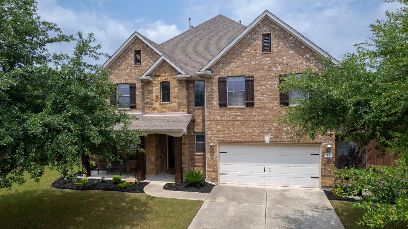 1232 Heep Run Buda, TX 78610 - Photo 1 of 1 a front view of a house with a yard and garage