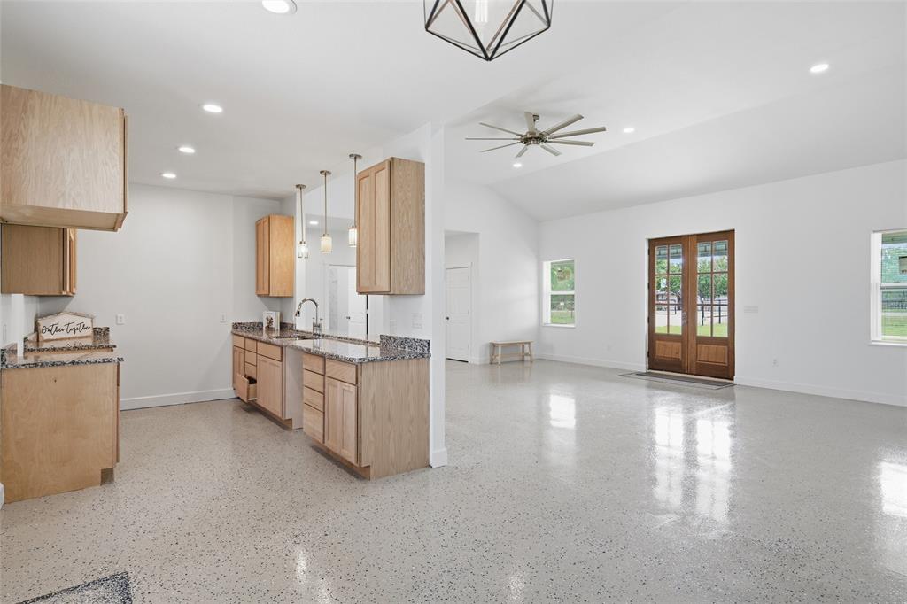 151 Kasberg Road Leroy, TX 76691 - Photo 7 of 40 a large white kitchen with a sink a stove and a chandelier