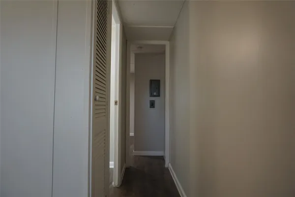 an empty room with a window and wooden floor