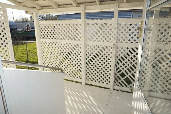 a view of a house with backyard and wooden fence