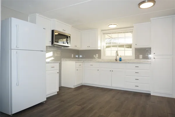 a bathroom with a sink vanity tub and a mirror