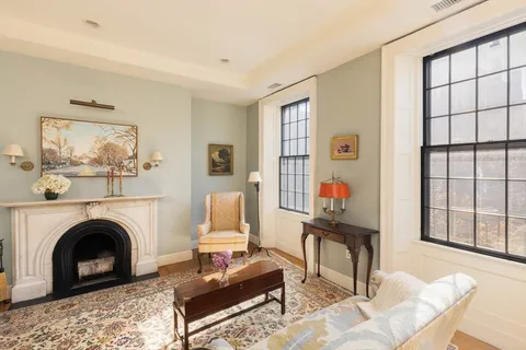 a living room with furniture a window and a fireplace