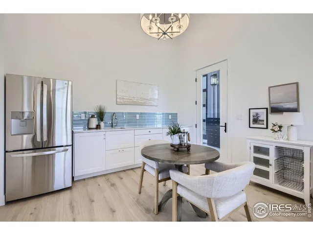 a living room with furniture a flat screen tv and a table