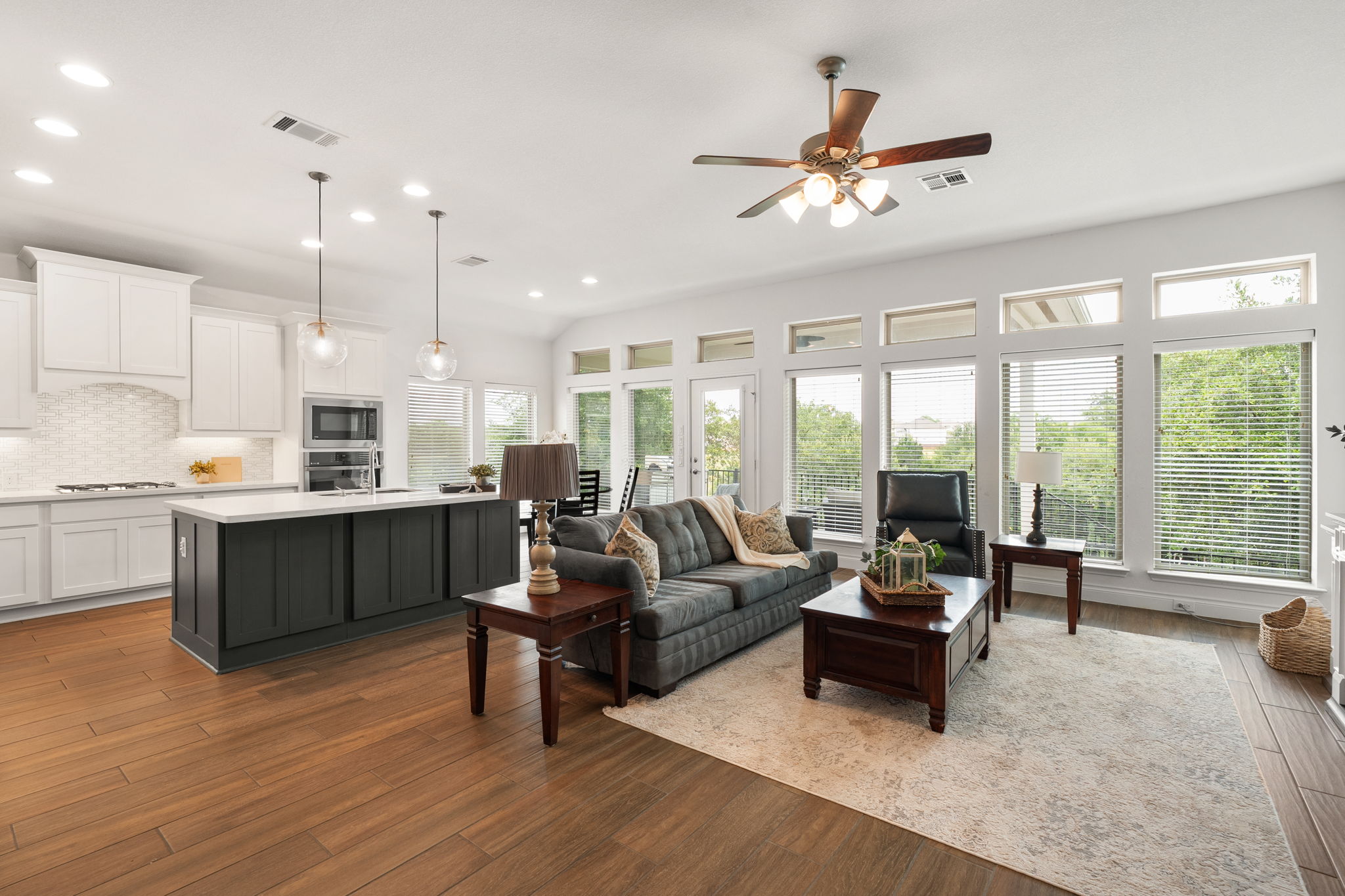 1908 Woolsey Way Leander, TX 78641 - Photo 4 of 36 An open-concept kitchen and family room with large, beautiful windows showcasing the backyard.