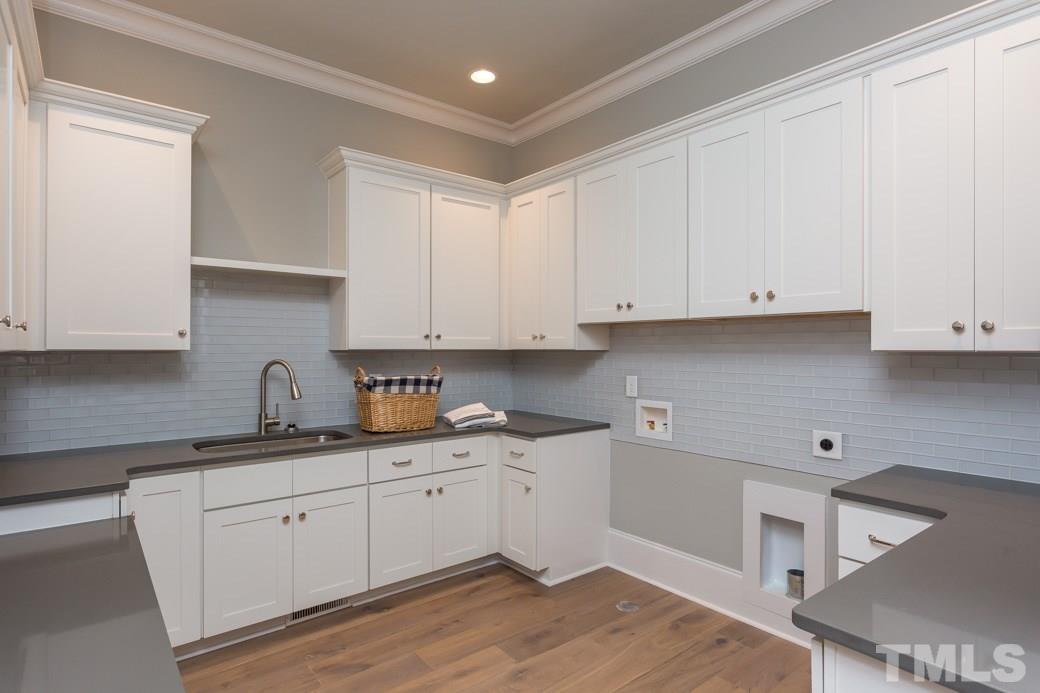 3208 Cobblestone Court Raleigh, NC 27607 - Photo 23 of 25 a kitchen with granite countertop white cabinets and white appliances