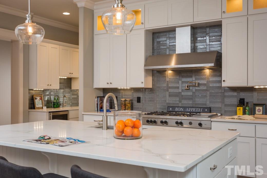 3208 Cobblestone Court Raleigh, NC 27607 - Photo 6 of 25 a kitchen with a stove and a cabinets