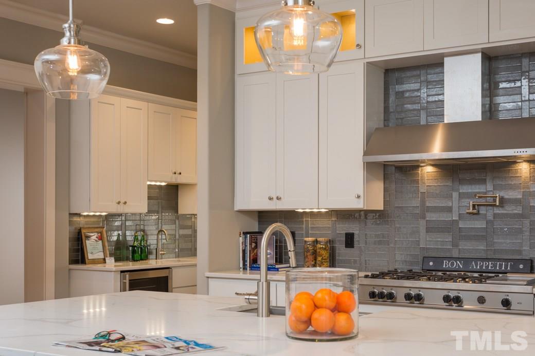 3208 Cobblestone Court Raleigh, NC 27607 - Photo 7 of 25 a kitchen with stainless steel appliances granite countertop a stove a sink and a microwave