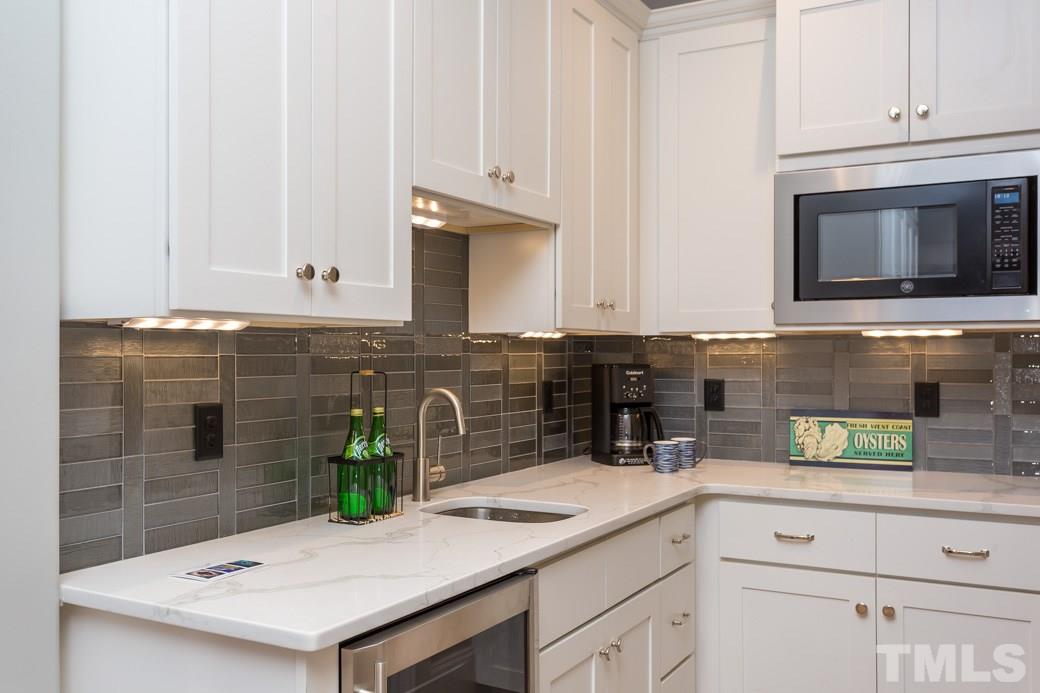 3208 Cobblestone Court Raleigh, NC 27607 - Photo 10 of 25 a kitchen with granite countertop white cabinets and white appliances