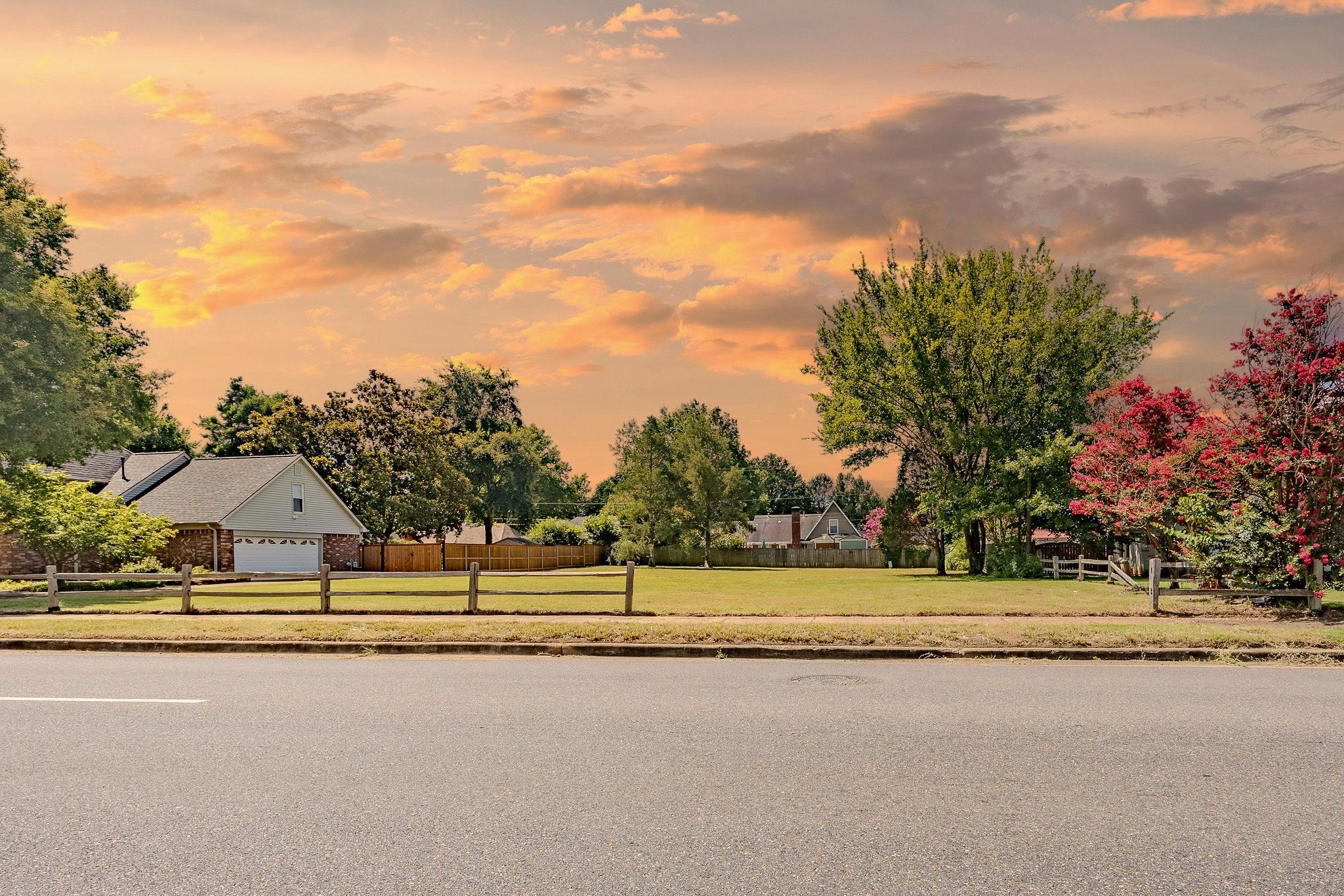 View of asphalt street with sidewalks and curbs