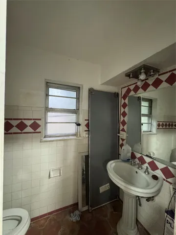 a bathroom with a sink and mirror